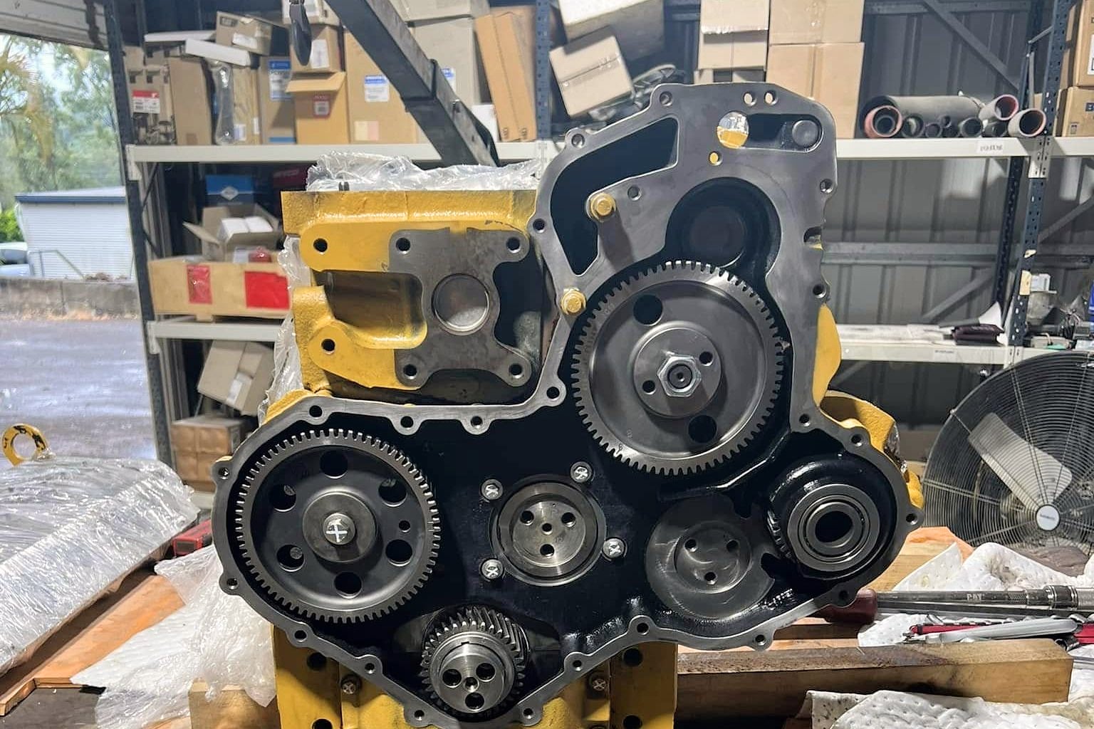 A diesel engine on the bench with its front gear train exposed