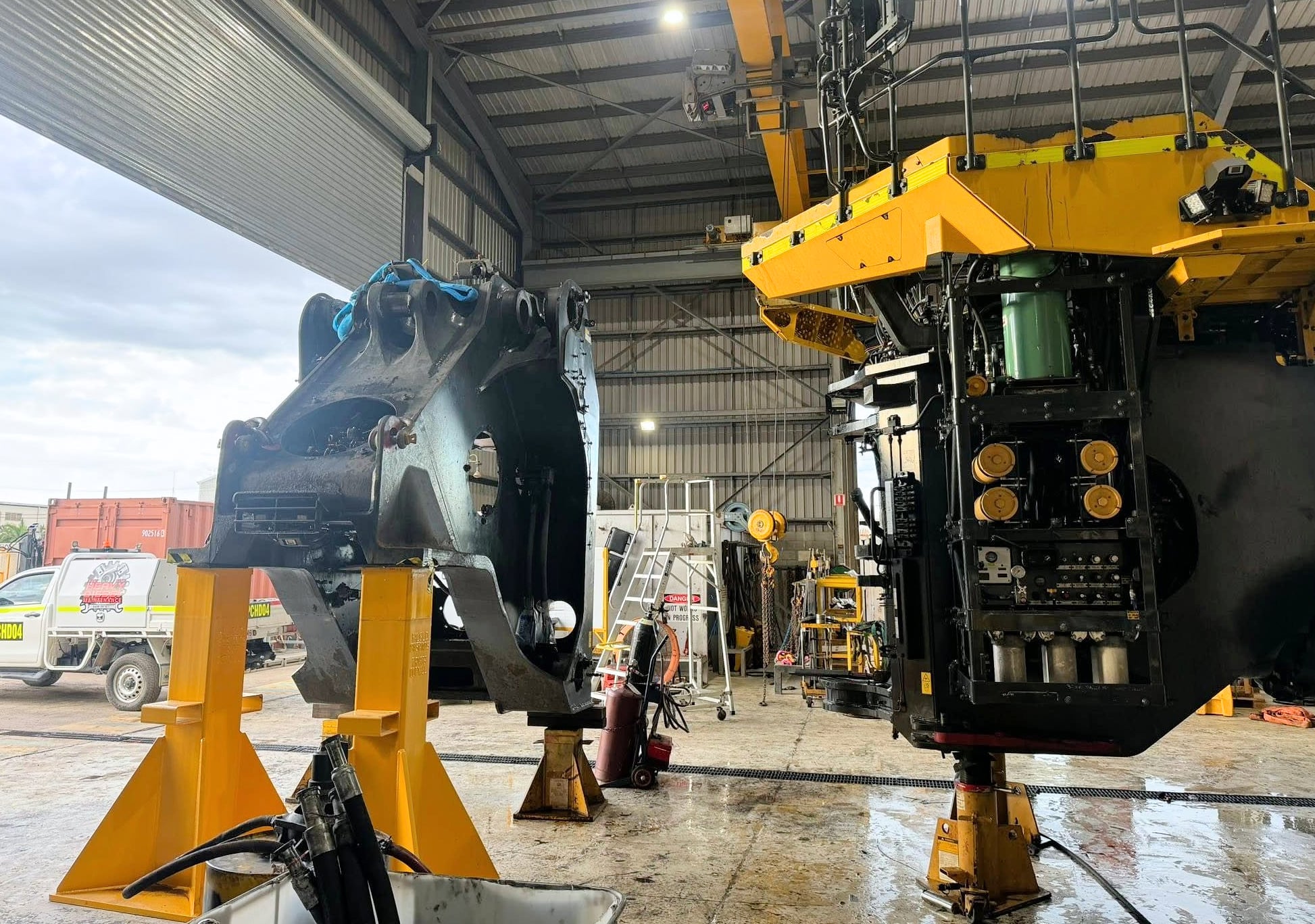 A large machine frame supported on stands inside the workshop